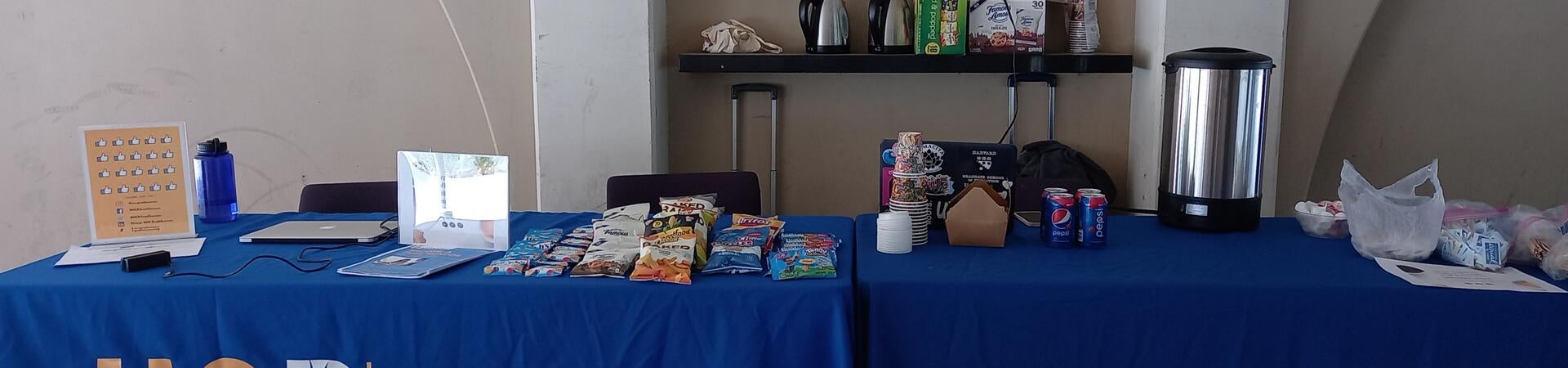 Coffee and snacks are presented on a GradSuccess table.