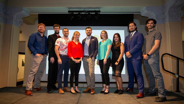 Group of Grad Slam Finalists standing all together on a stage