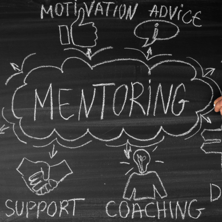 Mentoring written on a chalkboard inside an idea cloud with arrows pointing to other ideas outside the cloud