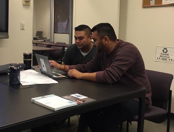 A consultant works with a student in GradQuant