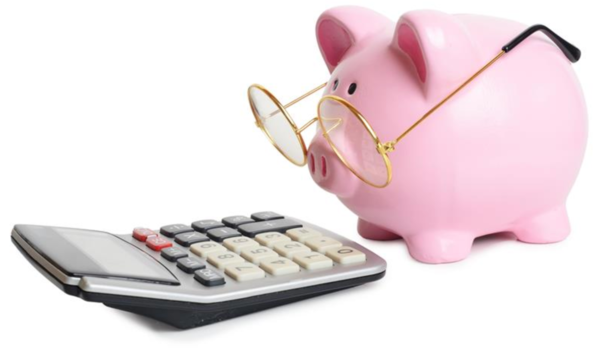 A piggy bank wearing glasses looking at a calculator 