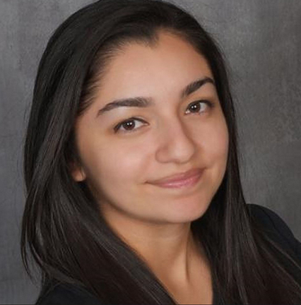 Head shot of Jessie in black shirt in front of gray backdrop