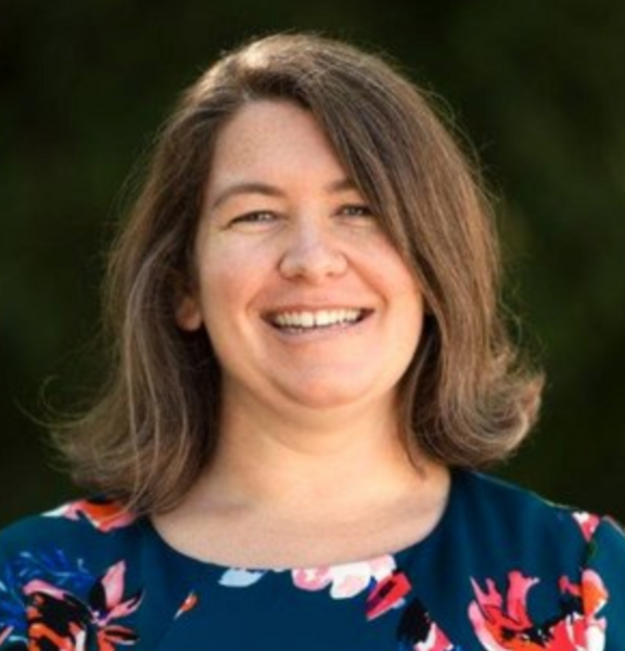 Photo of Anne smiling straight into camera wearing a flowered shirt