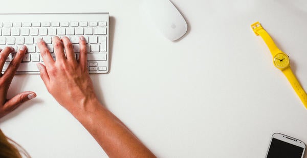 A woman types on her keyboard 