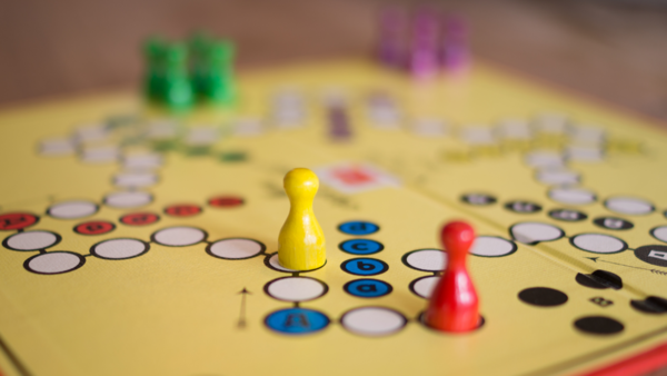 A Ludo board with two pieces in play